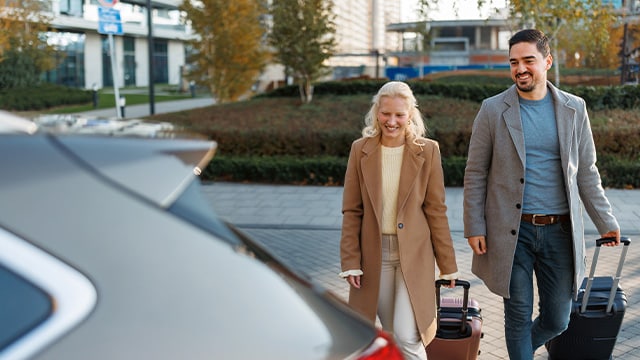 two business traveller walking to their car rental